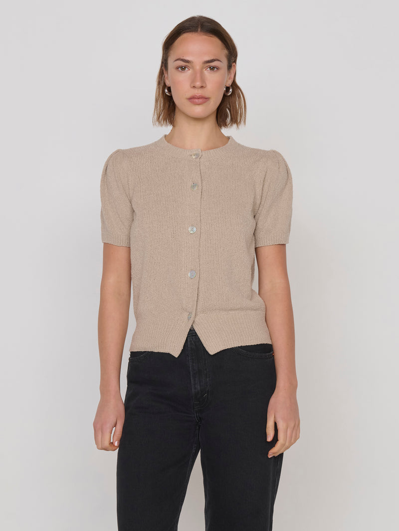 Woman in a beige textured short-sleeve cardigan 
