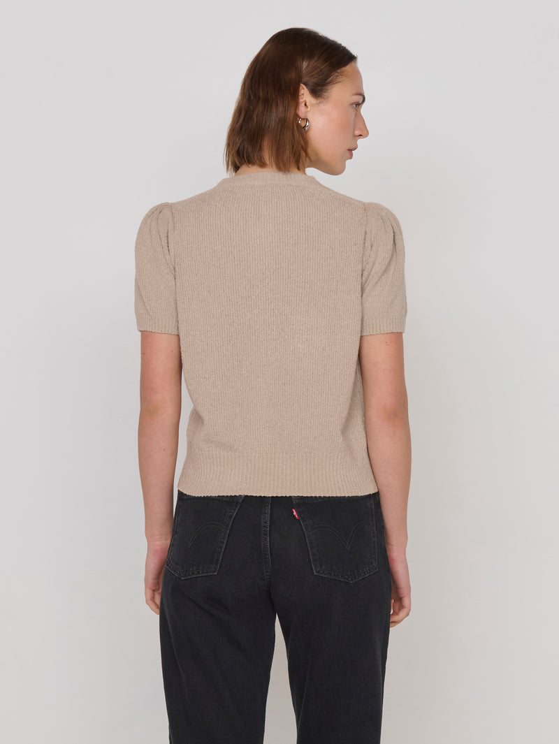 Woman in a beige textured short-sleeve cardigan 
