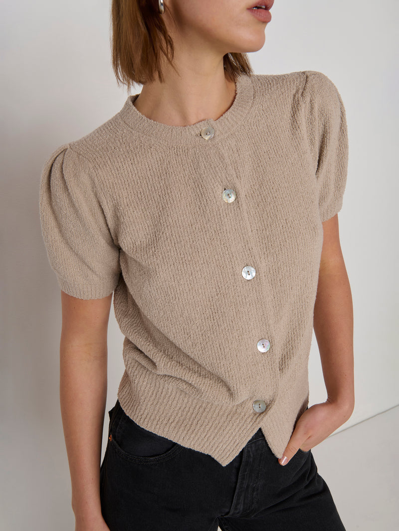 Woman in a beige textured short-sleeve cardigan 