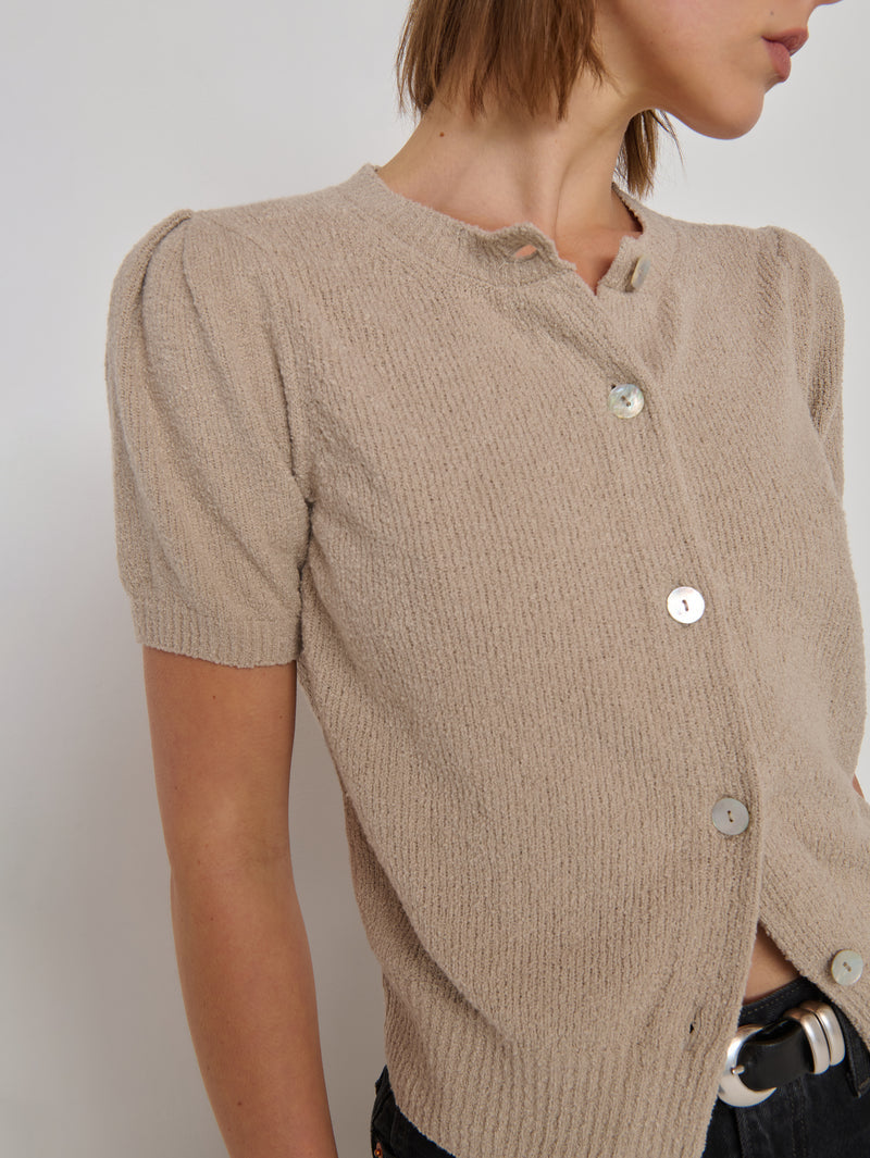 Woman in a beige textured short-sleeve cardigan 