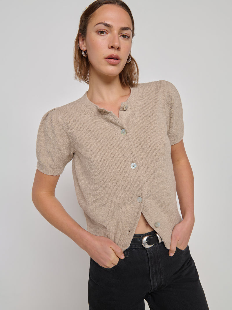 Woman in a beige textured short-sleeve cardigan 