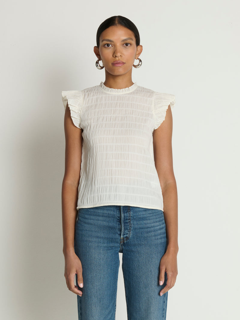 Woman wearing a white ruffle top 