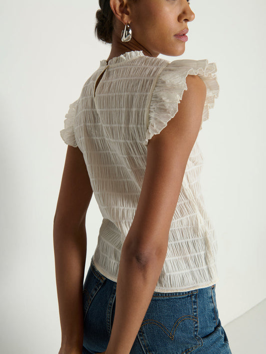 Woman wearing a white ruffle top