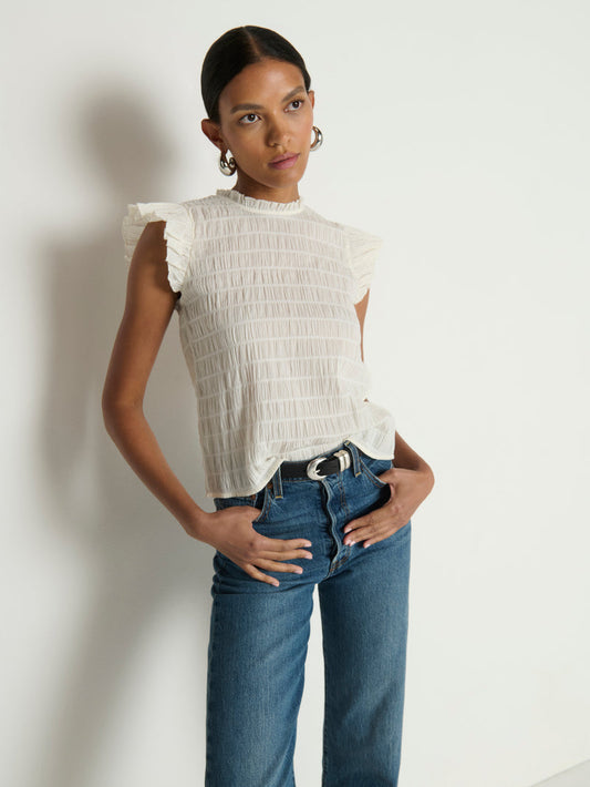 Woman wearing a white ruffle top 