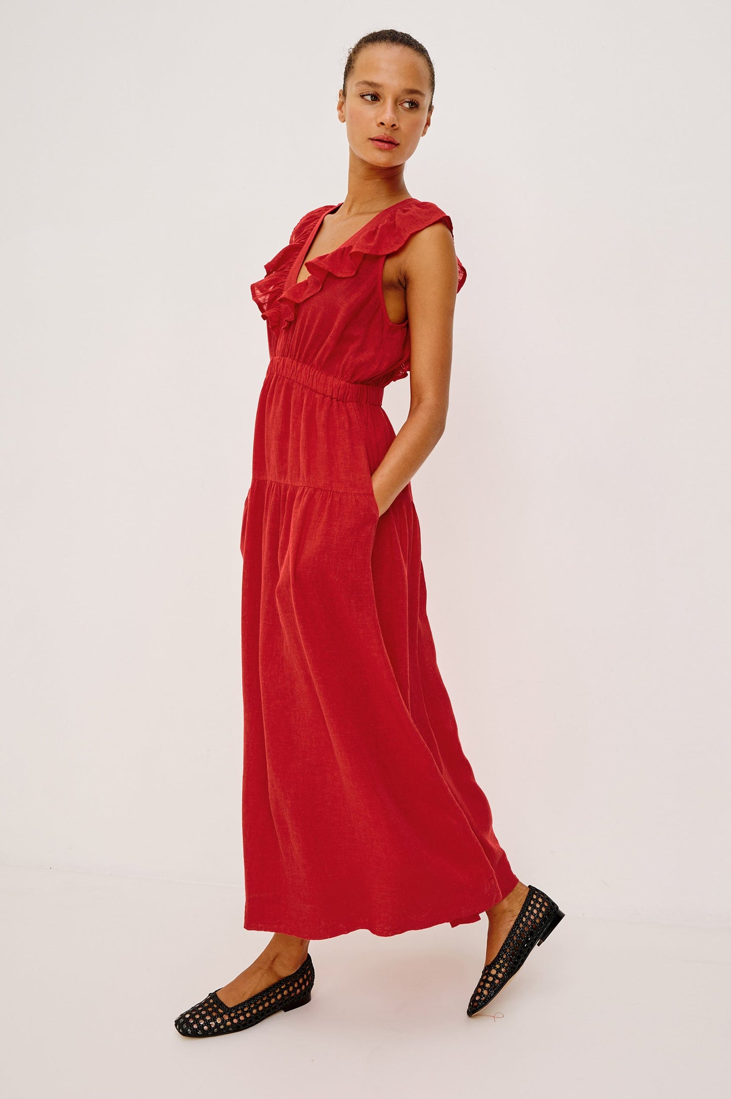 Woman wearing a red dress with ruffled details