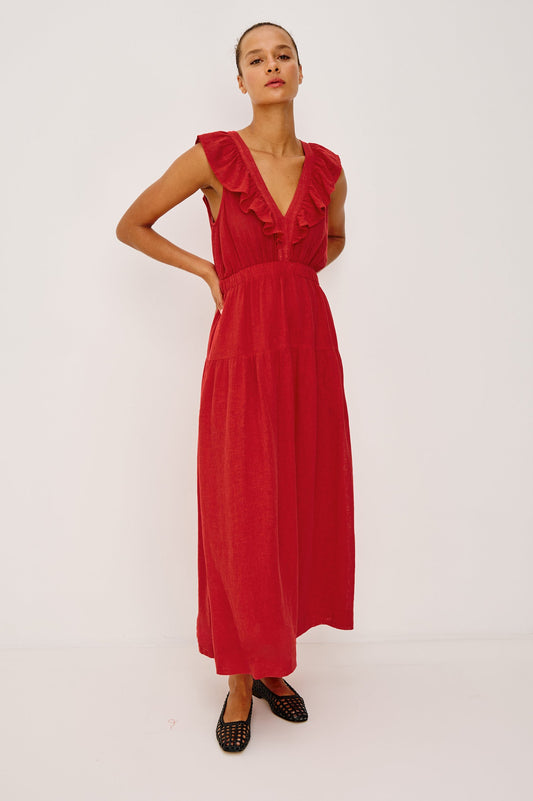 Woman wearing a red dress with ruffled details