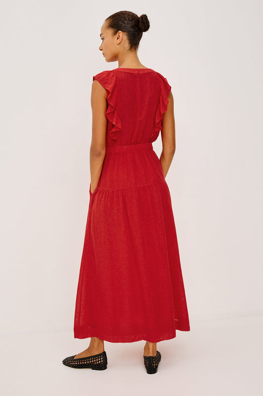 Woman wearing a red dress with ruffled details