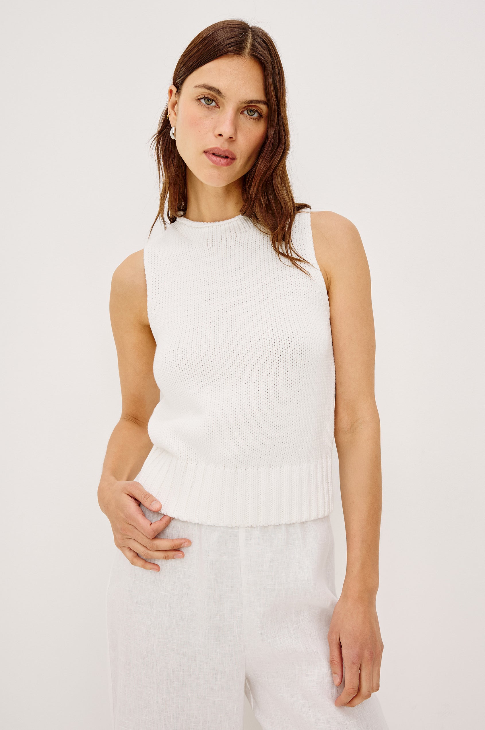 Woman wearing a white sleeveless top 