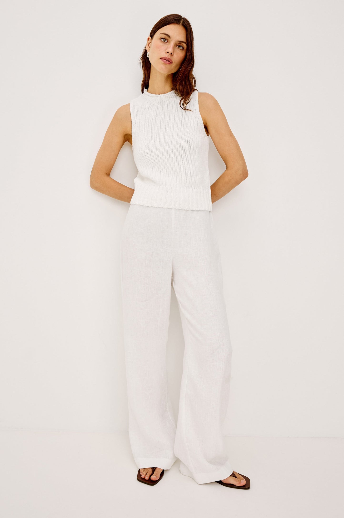 Woman wearing a white sleeveless top 