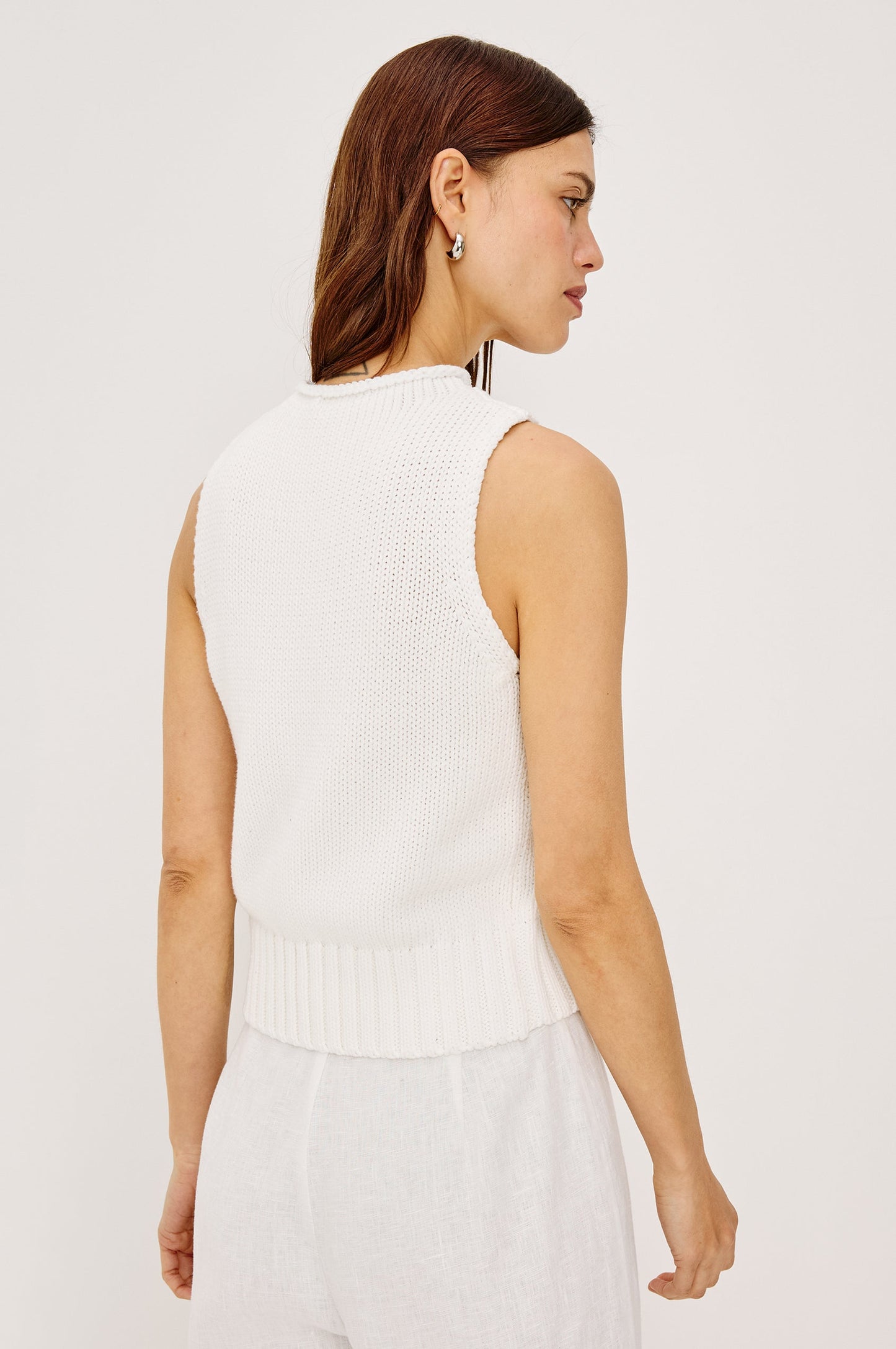 Woman wearing a white sleeveless top 