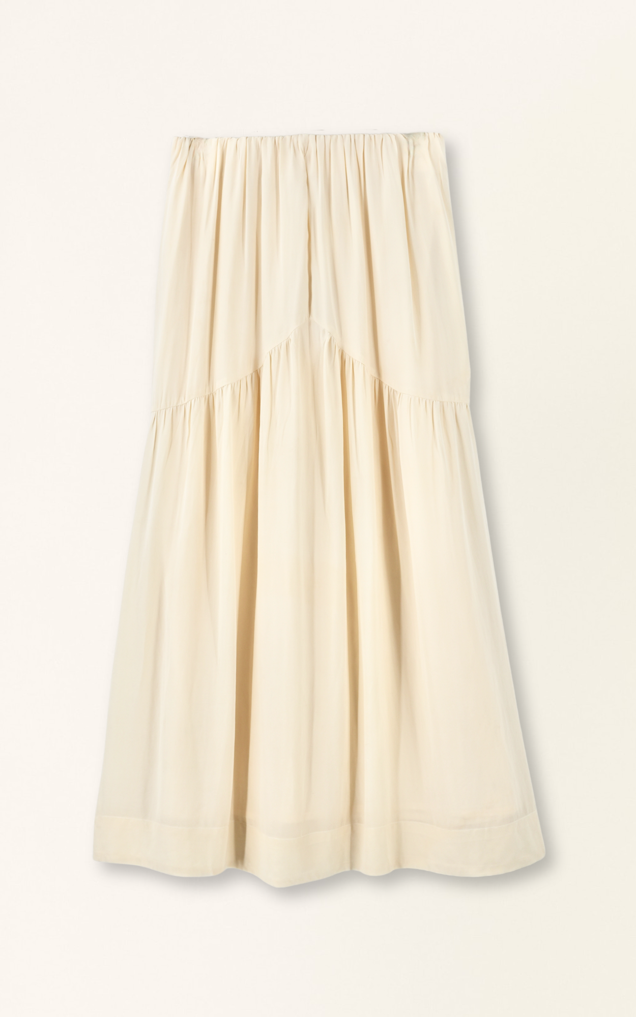 Cream silk skirt with flowy silhouette, gathered accents, and a subtle ruffle at the top; ideal for casual or dressy wear.