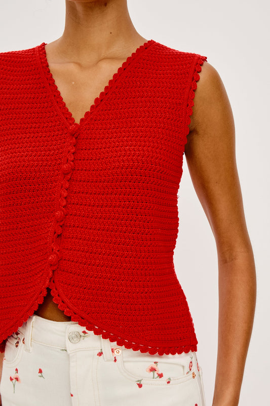 Woman wearing a red sleeveless top