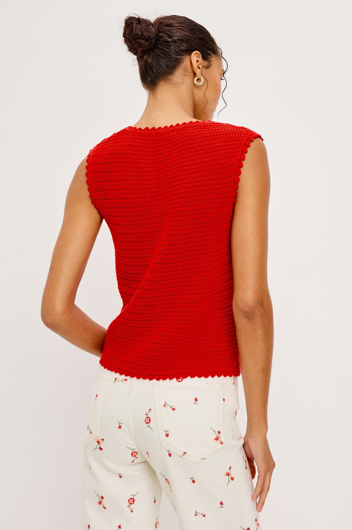 Woman wearing a red sleeveless top