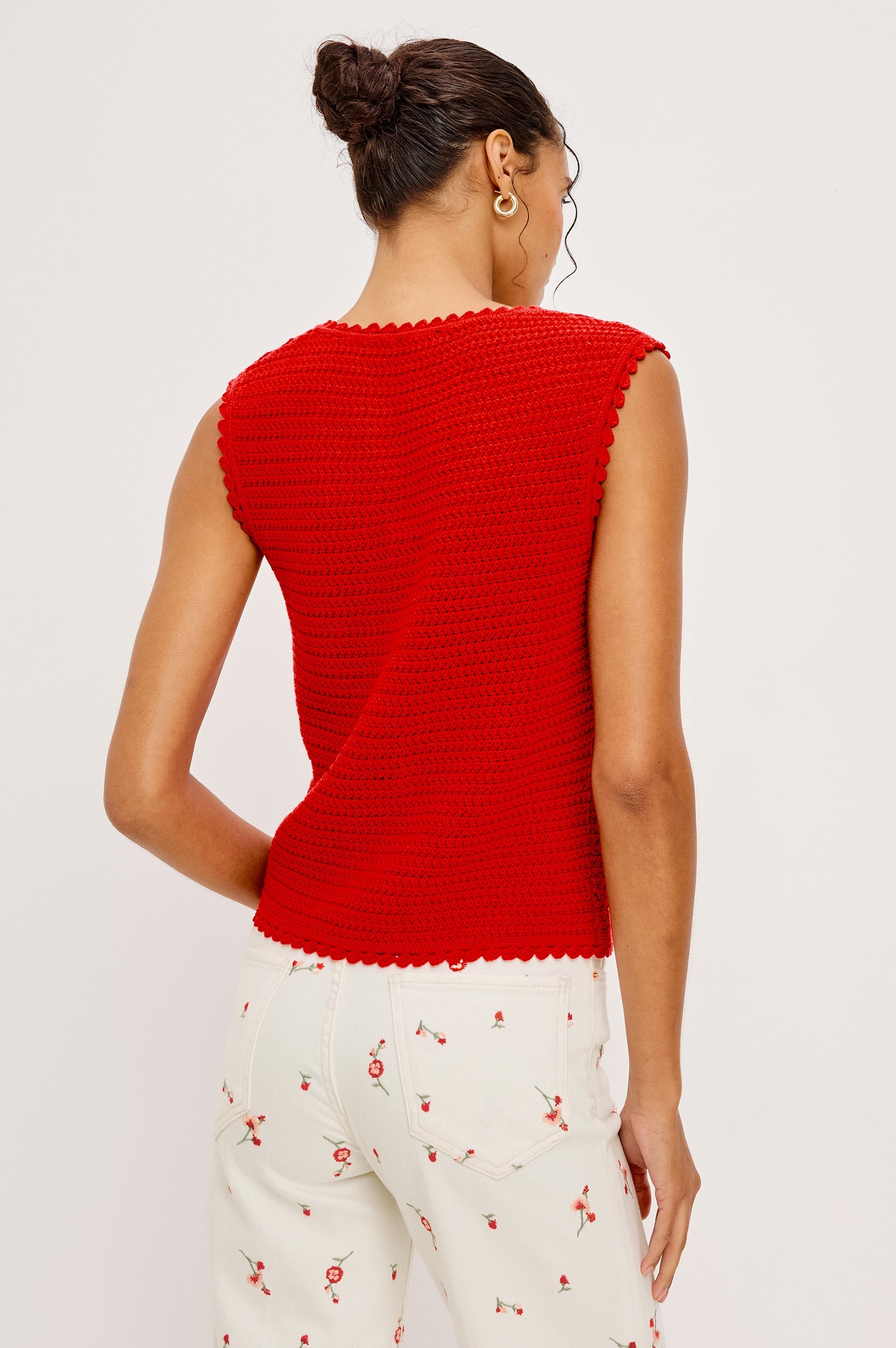 Woman wearing a red sleeveless top