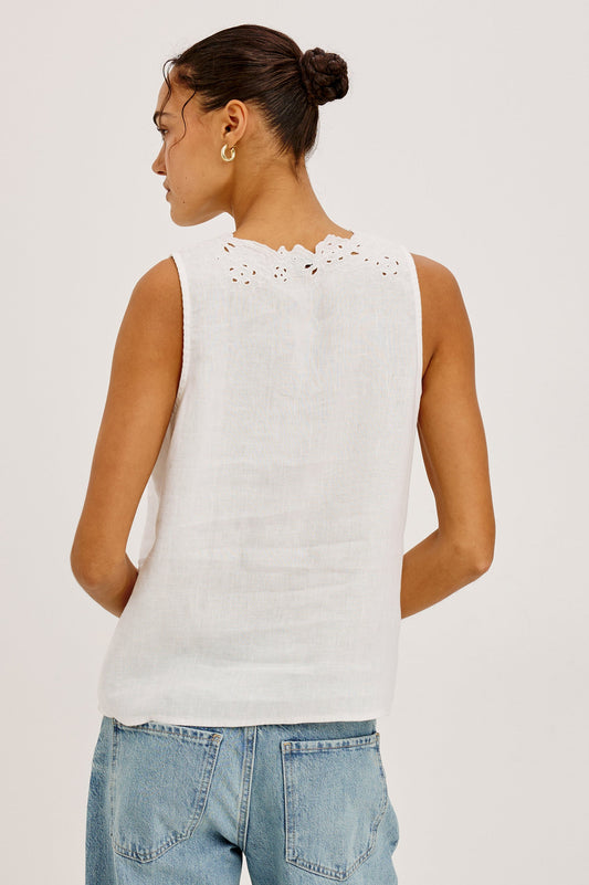 Woman wearing a white sleeveless top with lace details