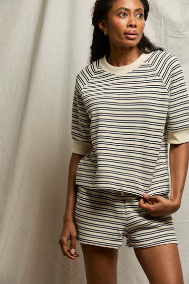 Woman wearing a perfectwhitetee striped matching set against a plain background