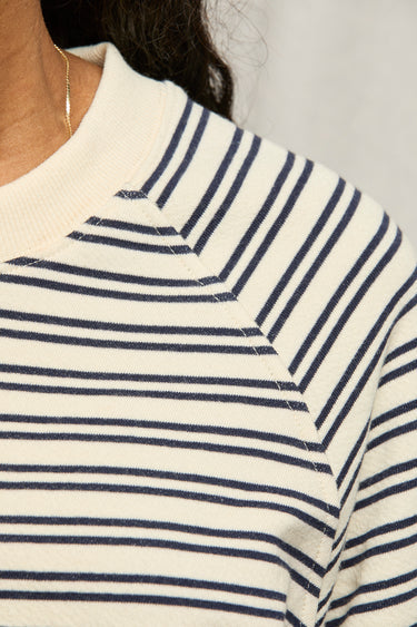 Woman wearing a perfectwhitetee striped matching set against a plain background
