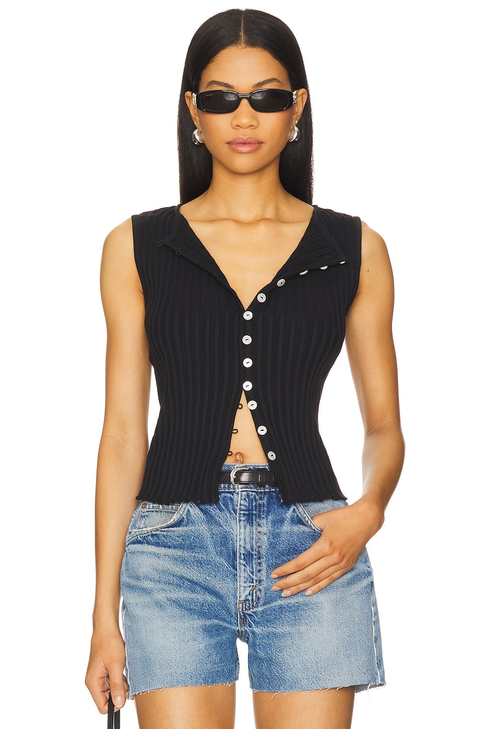 Woman in black vest top with buttons 