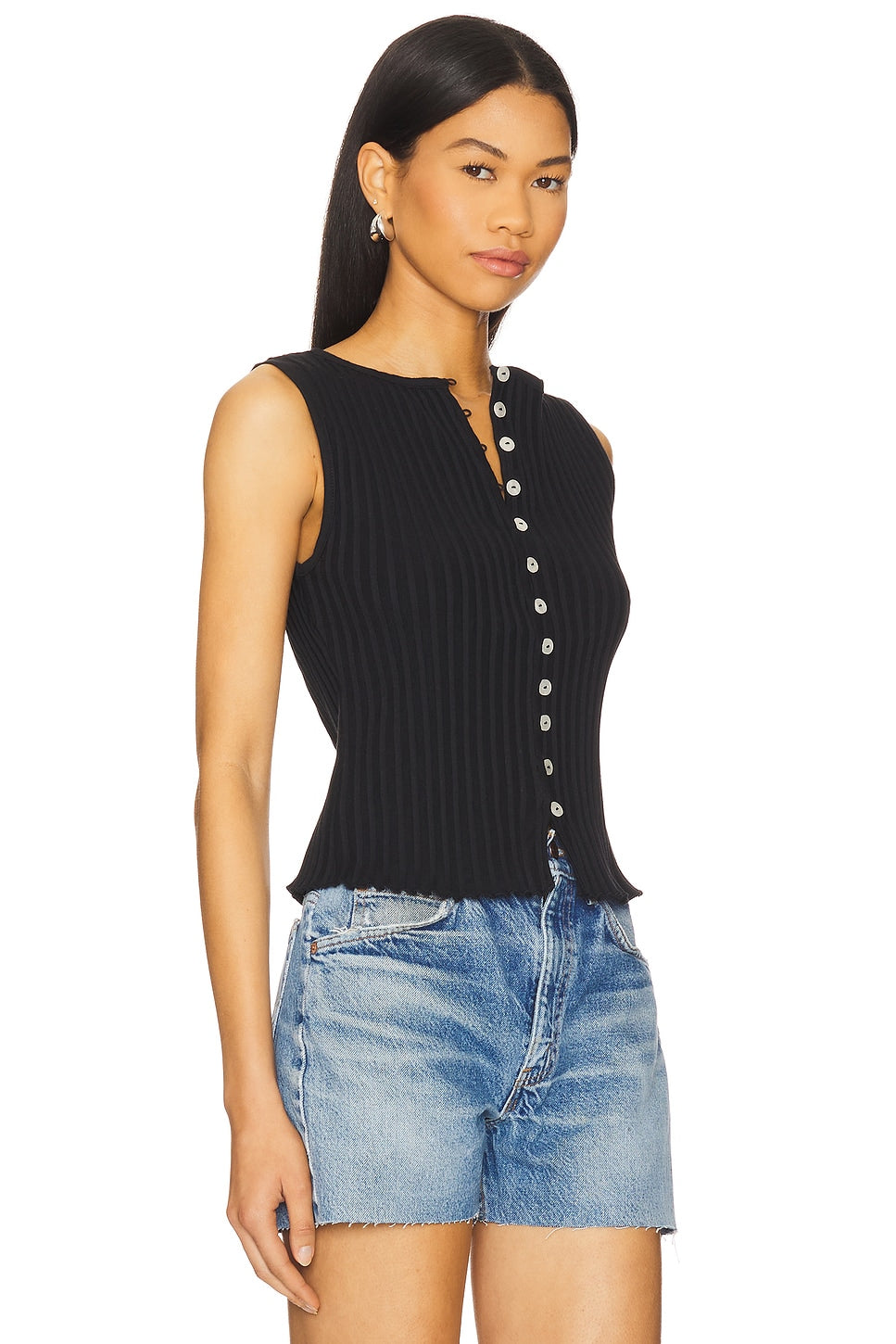 Woman in black vest top with buttons 