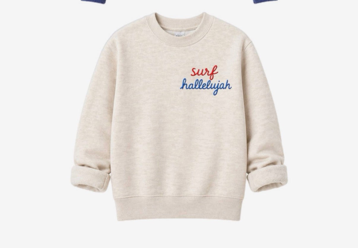 Beige embroidered sweatshirt with rolled sleeves and red/blue lettering on chest; casual cotton for everyday wear.