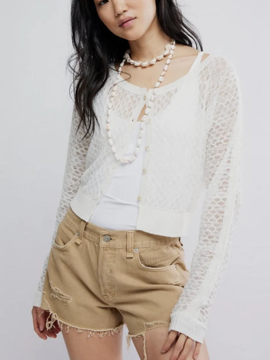 Sheer ivory cardigan over white tank and beige shorts, paired with beaded necklaces. Light, casual layering piece.
