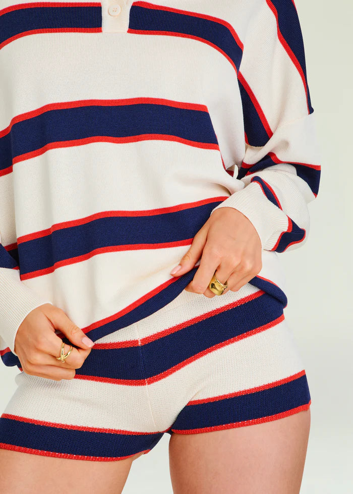 Eggshell striped knit sweater with gold rings worn on fingers. Sweater appears soft and casual, suitable for layering.