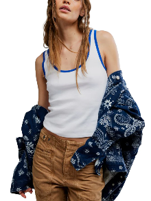 Ivory tank top, brown pants, and a blue patterned jacket worn off the shoulders.