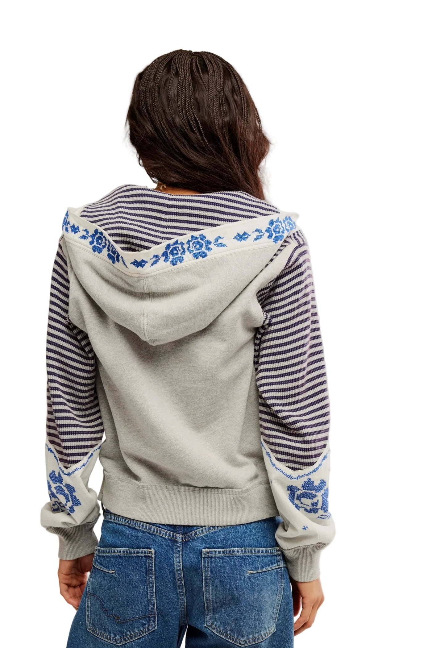 Grey zip-up jacket with blue patterns and striped sleeves, styled with blue jeans; casual outerwear for everyday use.