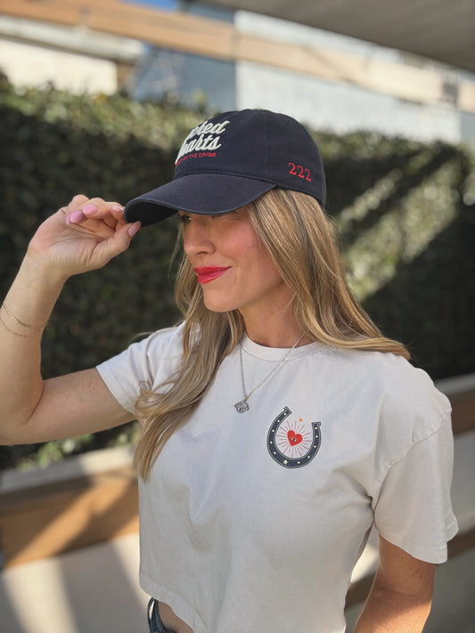 Woman outdoors in a white cotton t-shirt and gray cap, The Aligned 222 Hat, suitable for casual everyday wear.