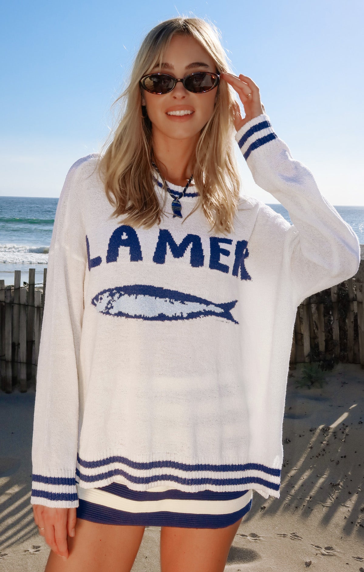 Woman in a white and blue graphic sweater