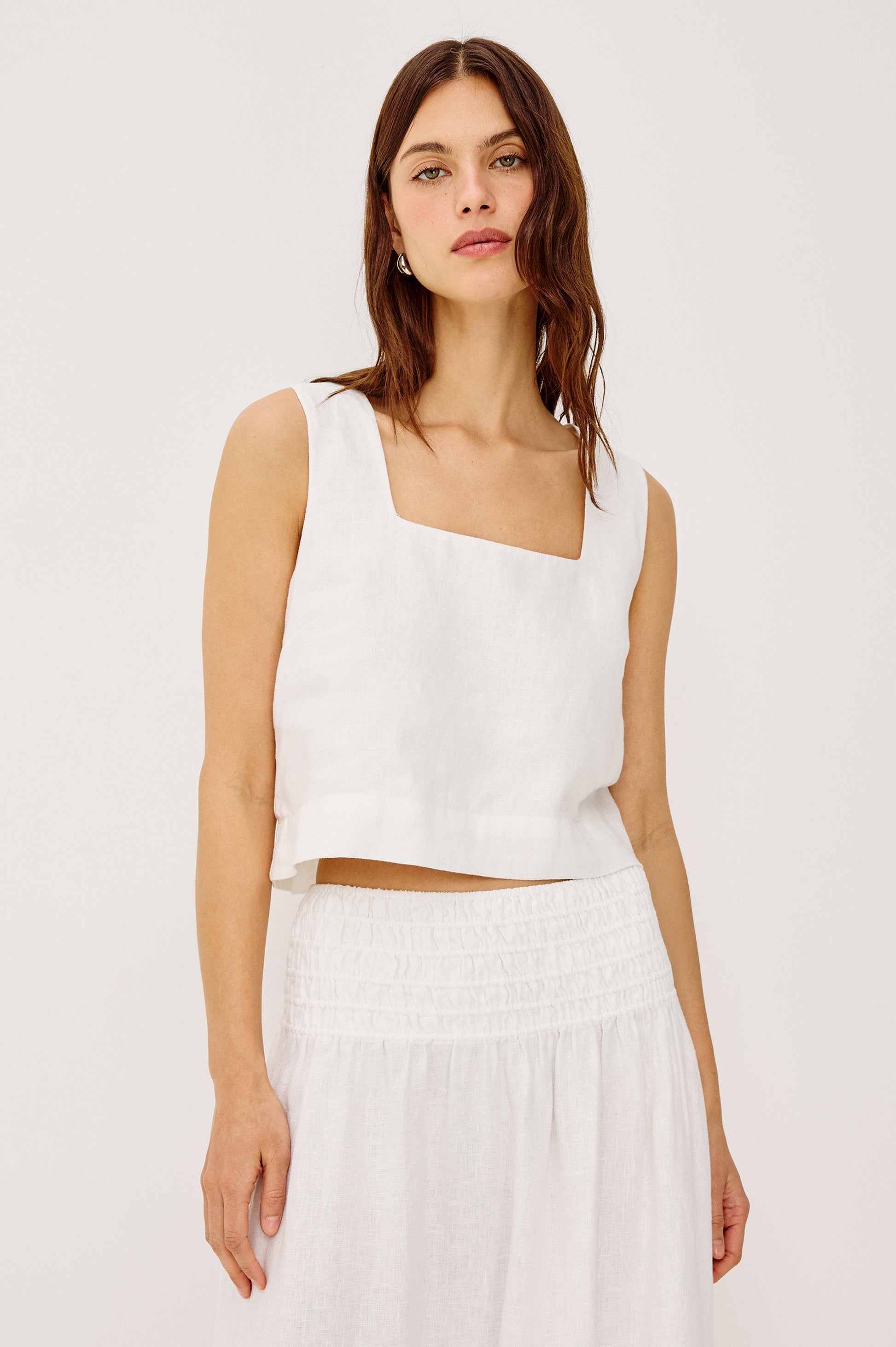 Woman wearing a white sleeveless top 