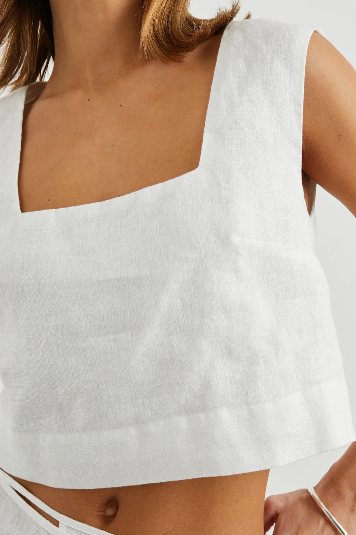 Woman wearing a white sleeveless top 