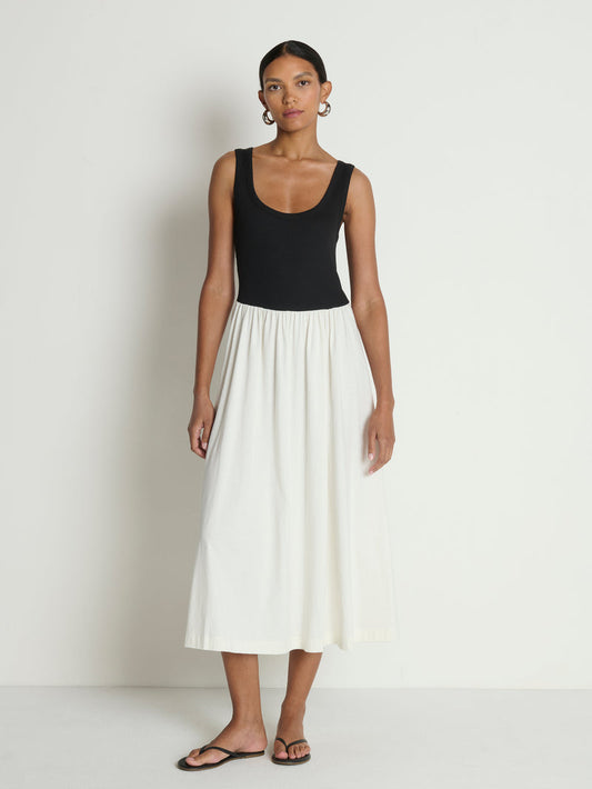 woman wearing a black and white midi dress