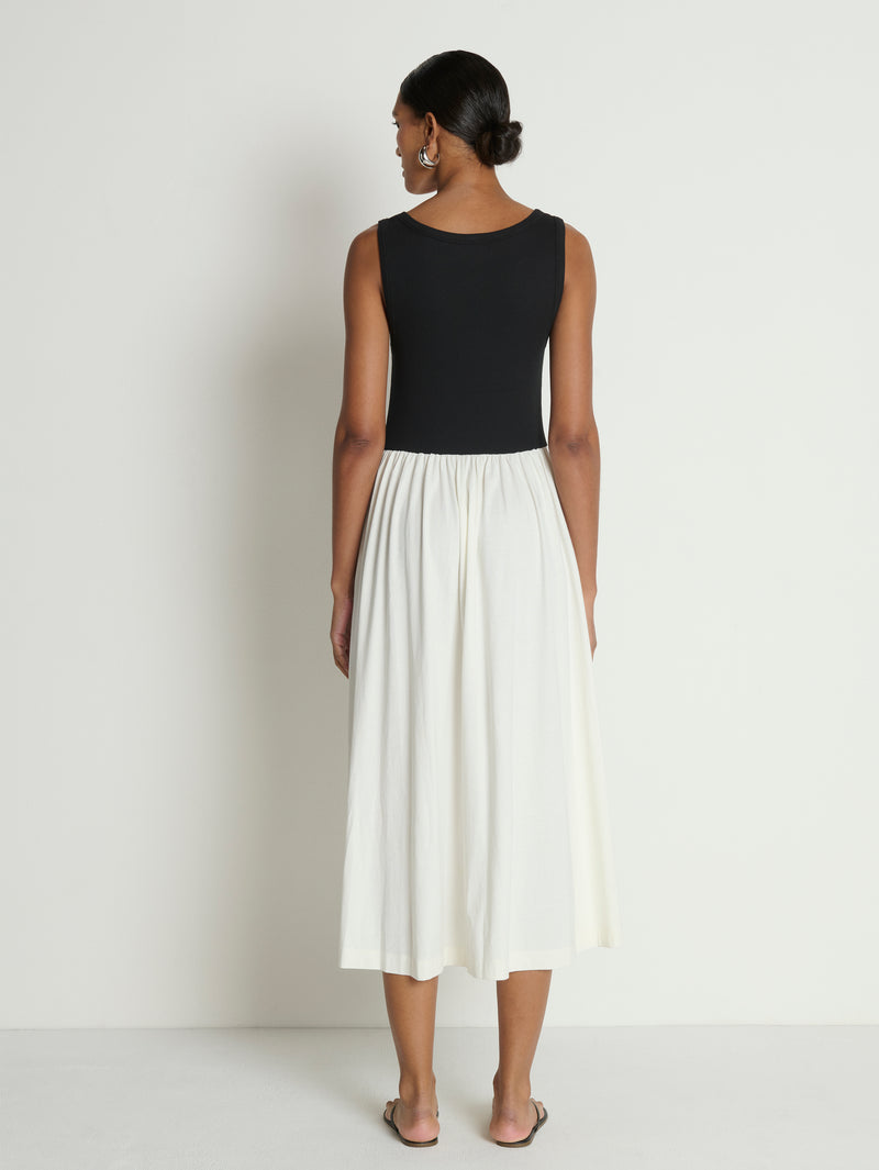 woman wearing a black and white midi dress