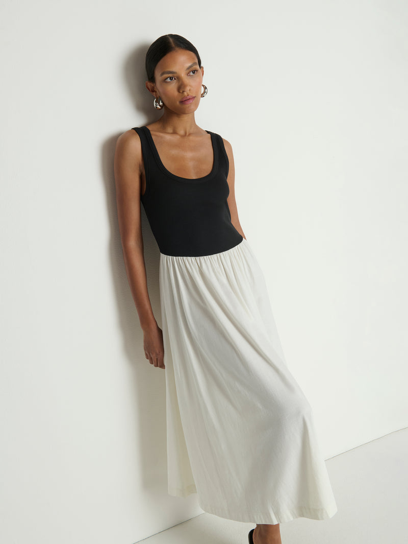woman wearing a black and white midi dress