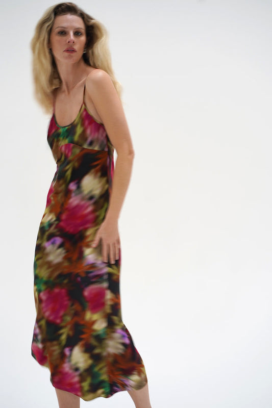 Josie Slip Dress in blurred floral print, midi length, lightweight fabric; model stands against white background.