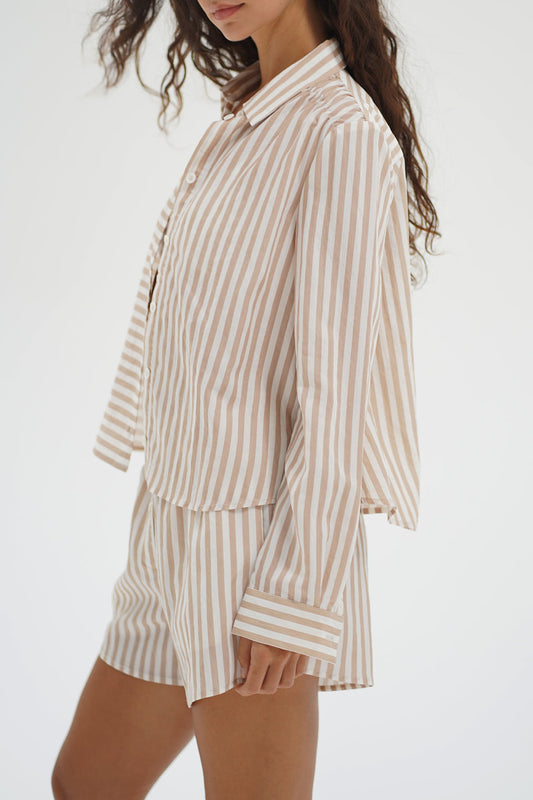 Woman wearing a beige and white striped shirt