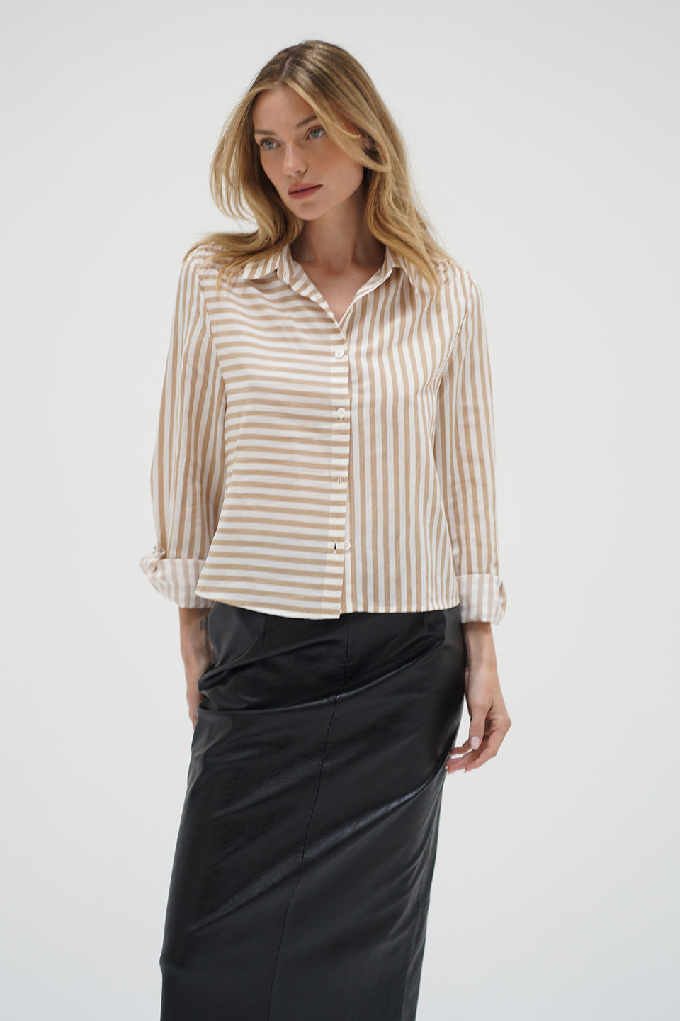 Woman wearing a beige and white striped shirt