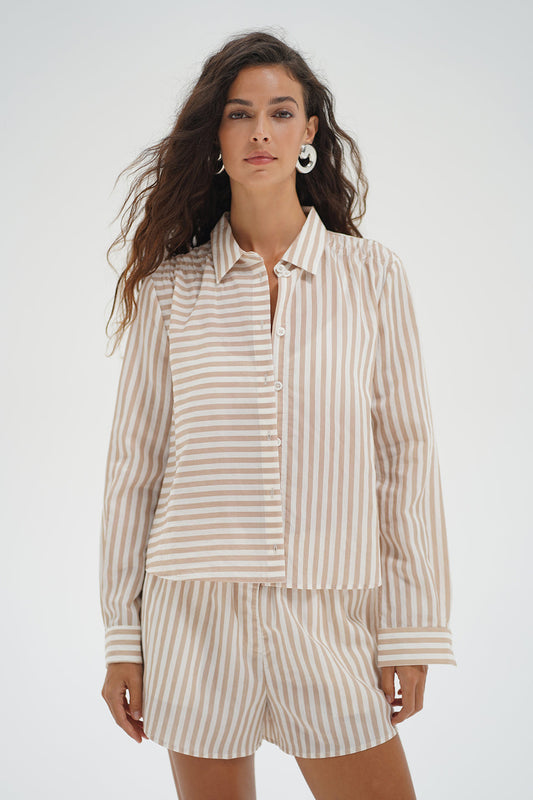 Woman wearing a beige and white striped shirt