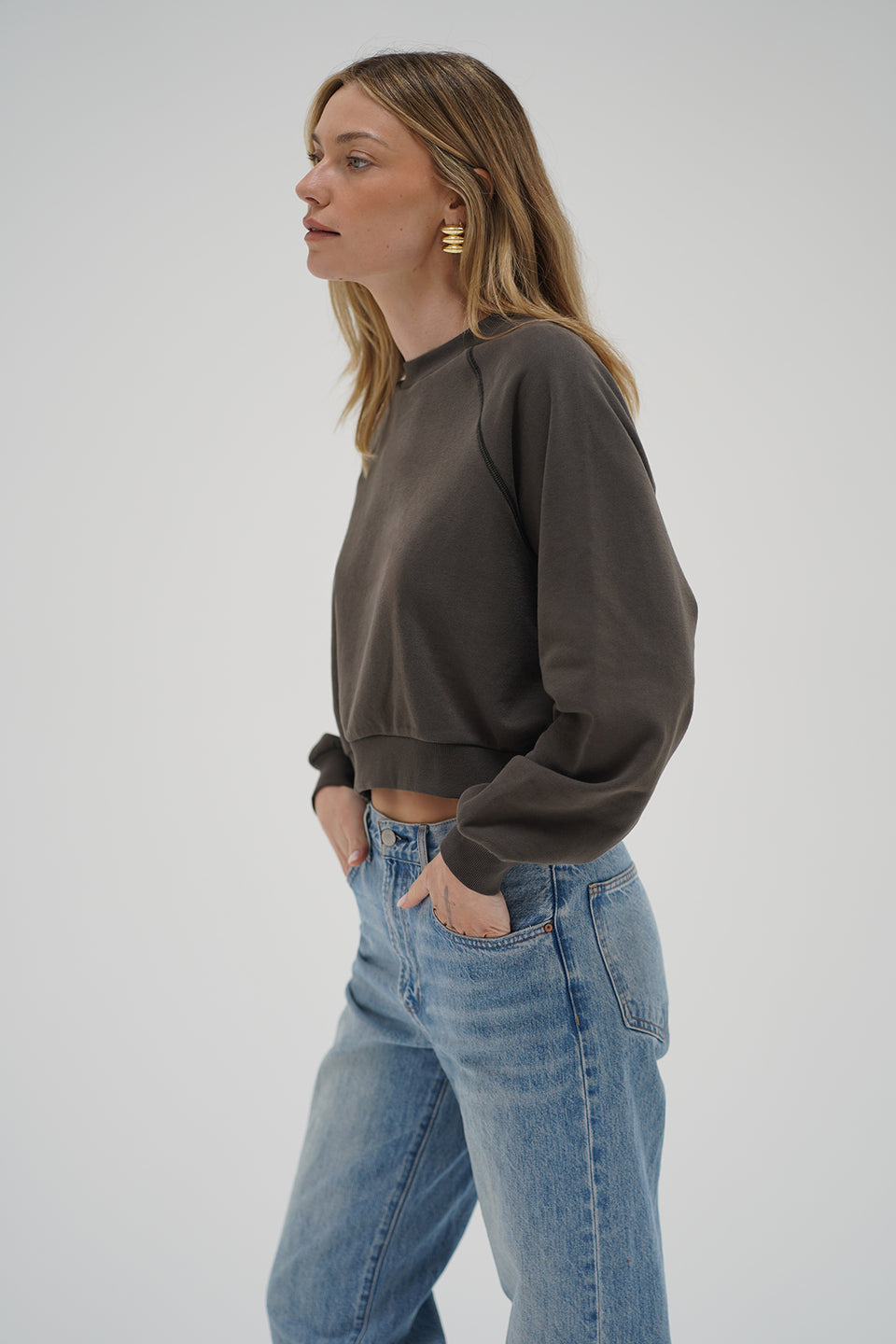 Woman wearing a brown cropped sweater 