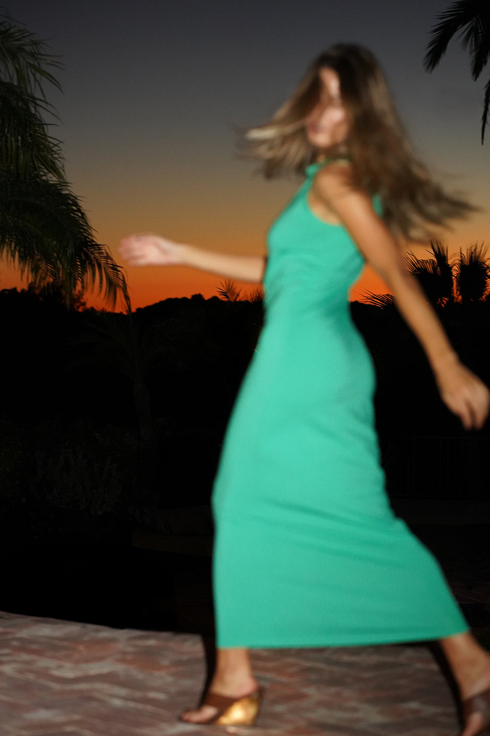 Woman in a green sleeveless maxi dress 