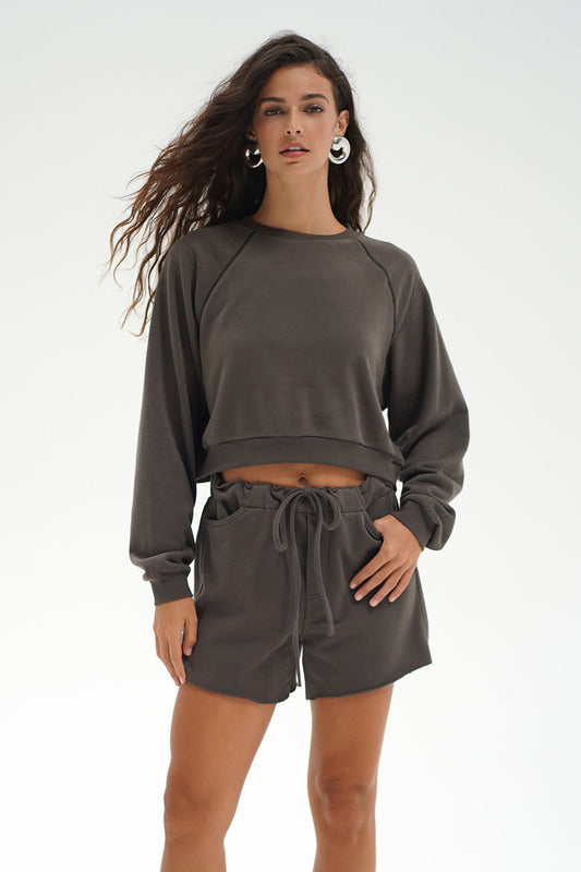 Woman wearing a gray sweatshirt and shorts set