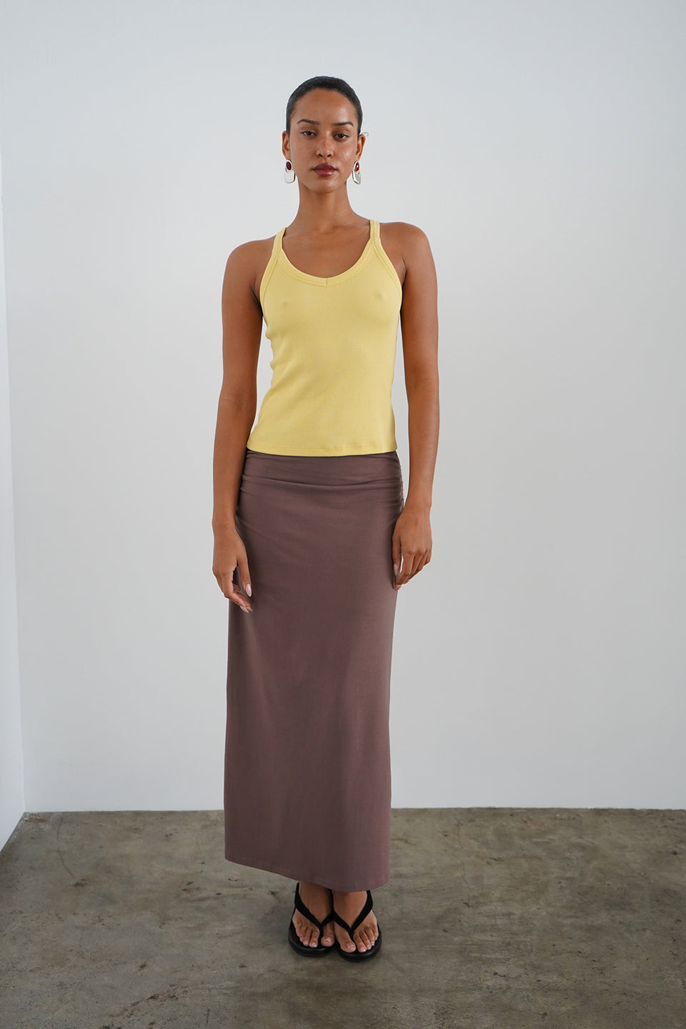 Woman wearing a yellow tank top