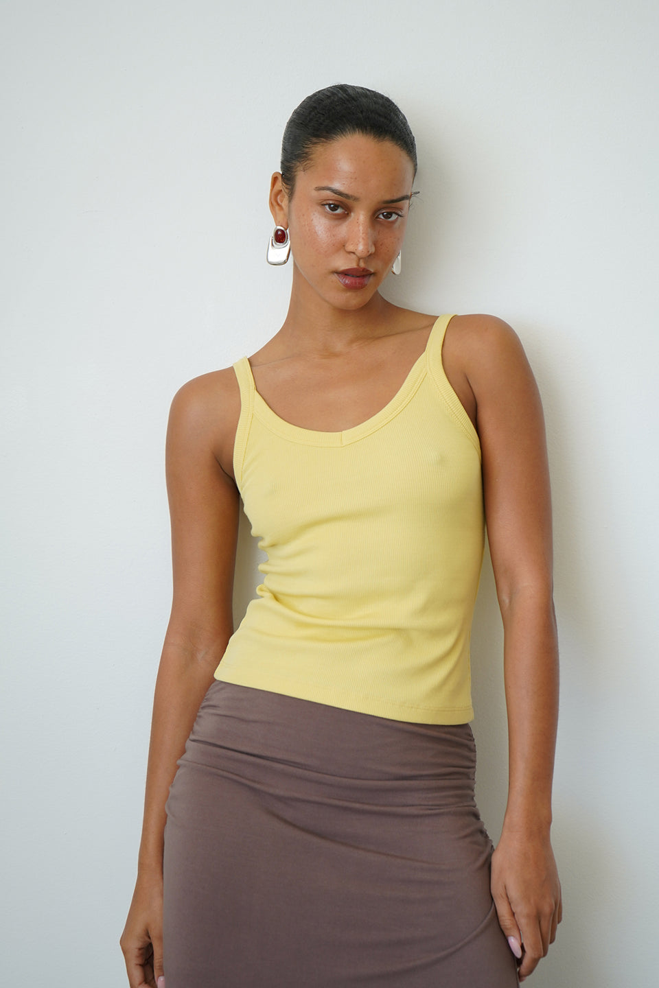 Woman wearing a yellow tank top