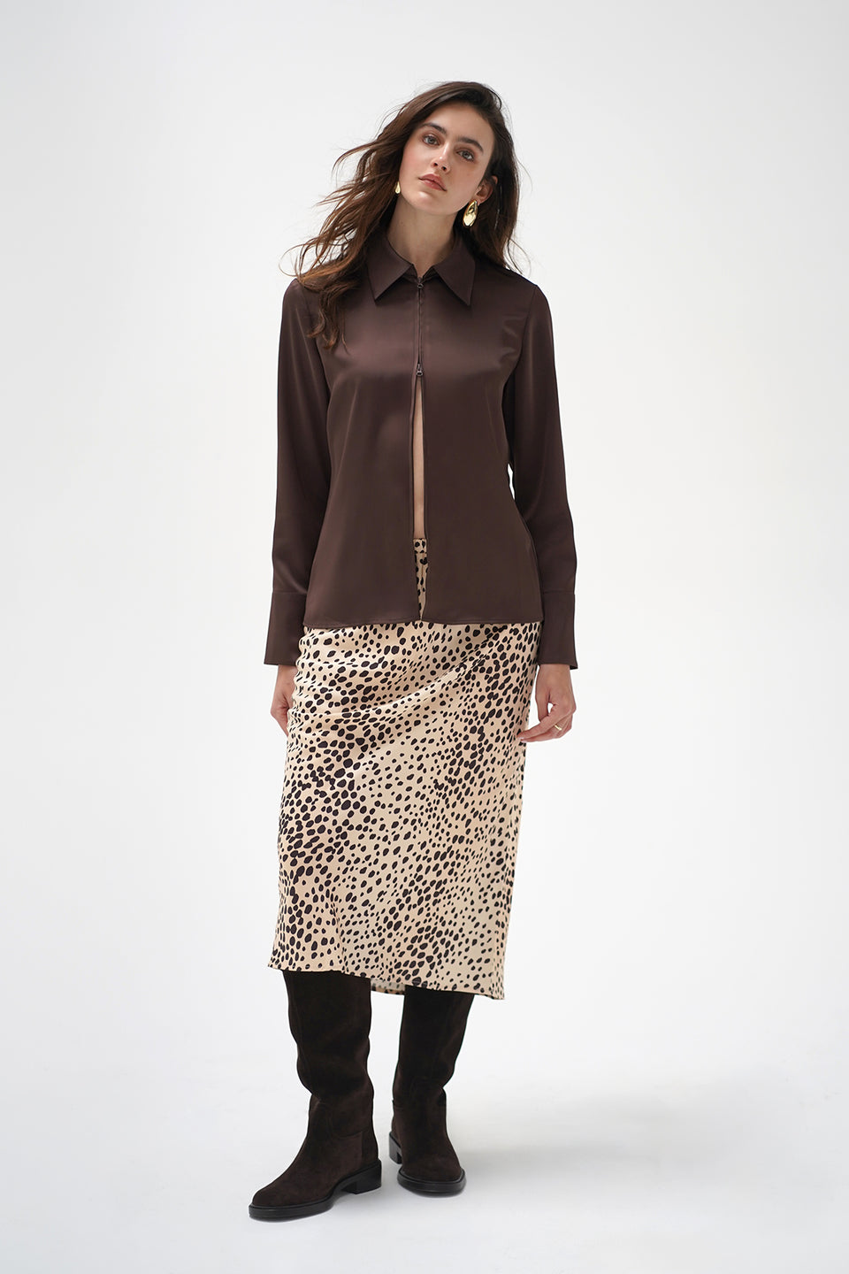 A model wearing a mid-length leopard print skirt