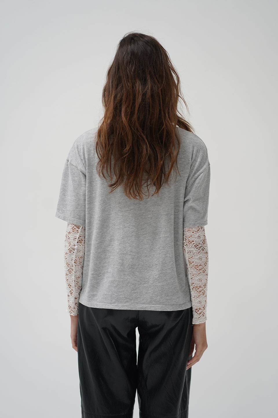 A woman in a two piece lace top