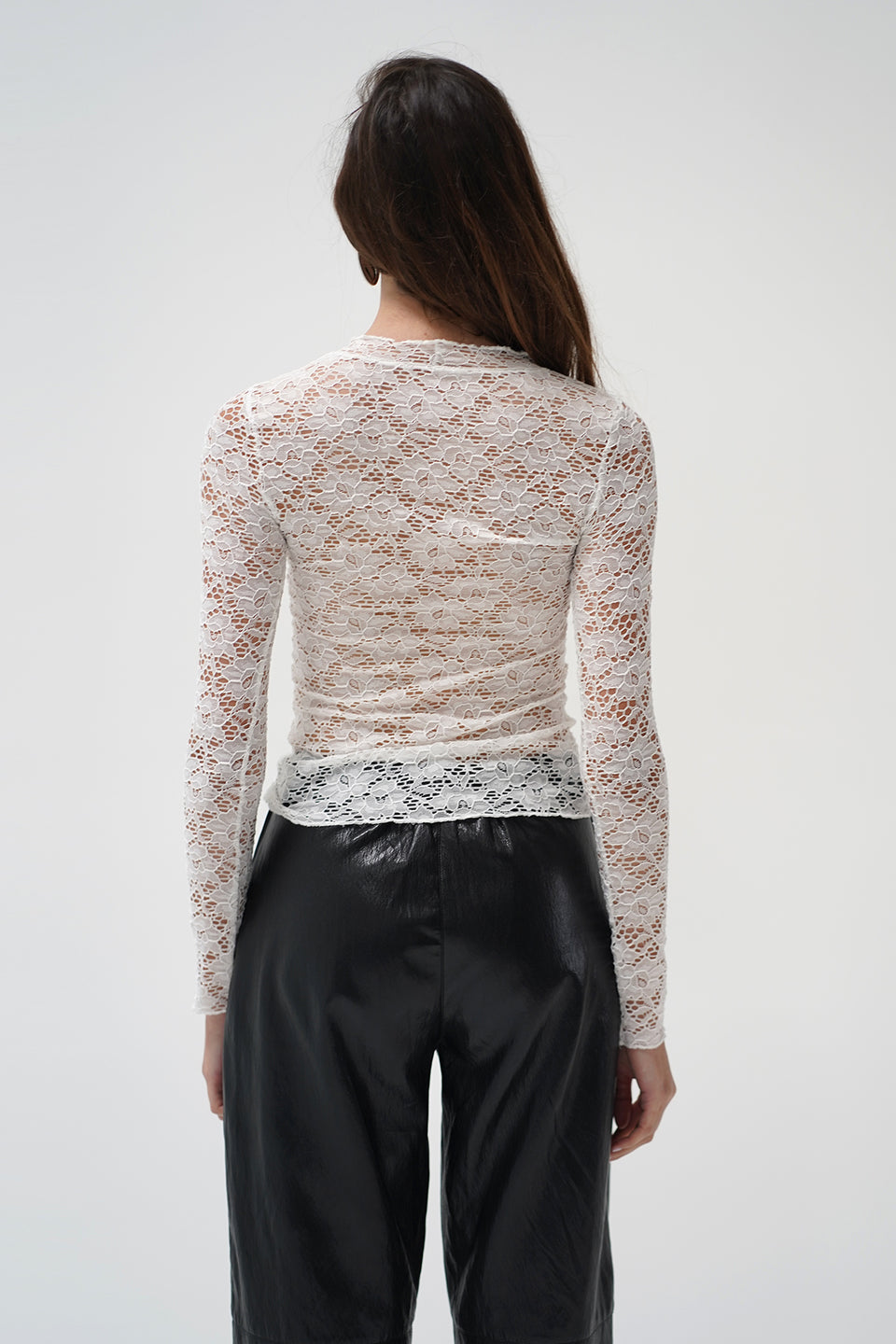 A woman in a two piece lace top