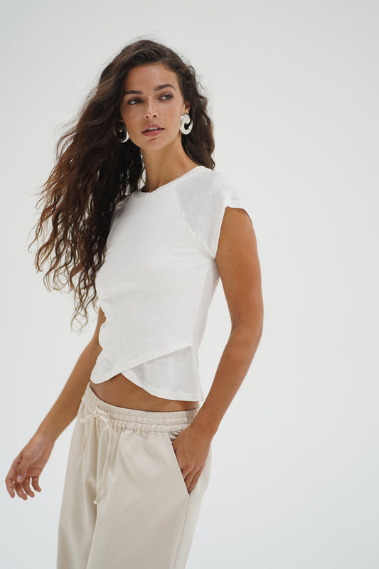 Woman wearing a white top with crisscross bottom