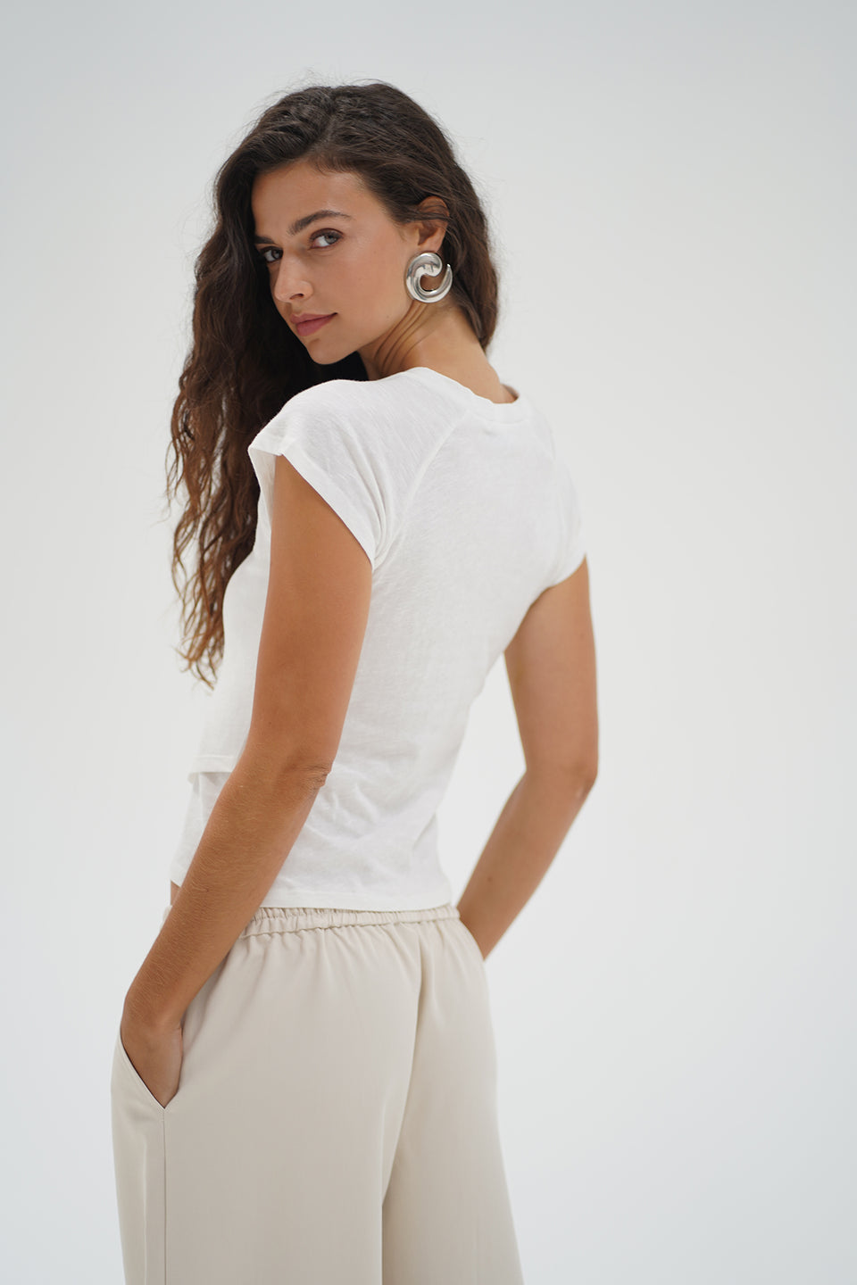 Woman wearing a white top with crisscross bottom