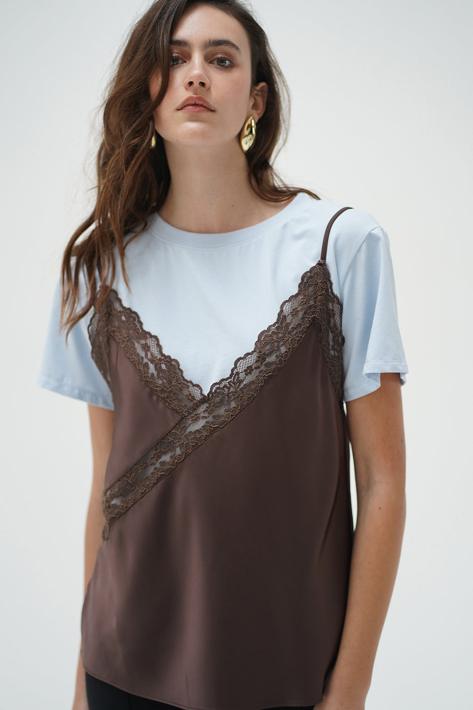 Woman wearing a cacao and blue Rowan cami layer tee, made of soft fabric, shown against a plain background.